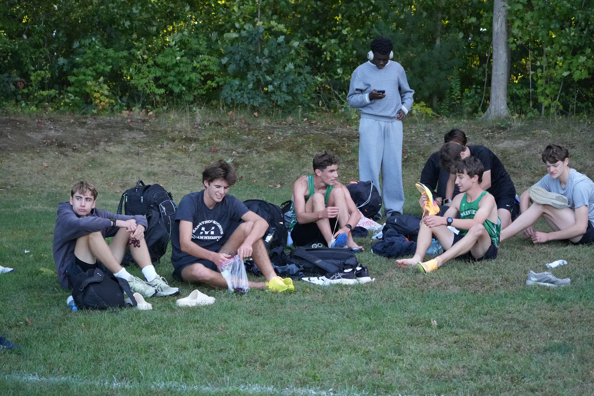 The boys settle on the grass after the race.